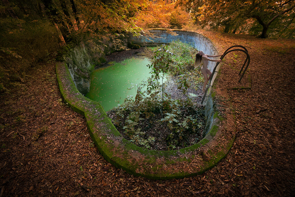 naked girl in an empty swimming pool